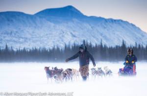 Race Marshal Kevin Saiki helps bring a team into the checkpoint [Photo by Albert Marquez/Planet Earth Adventures]